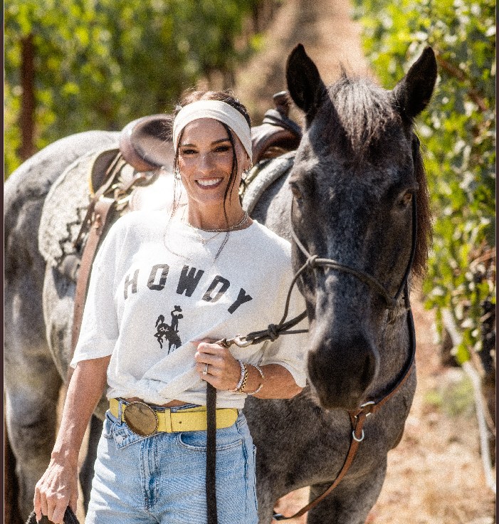 Heidi D'Amelio with a horse in the vineyard